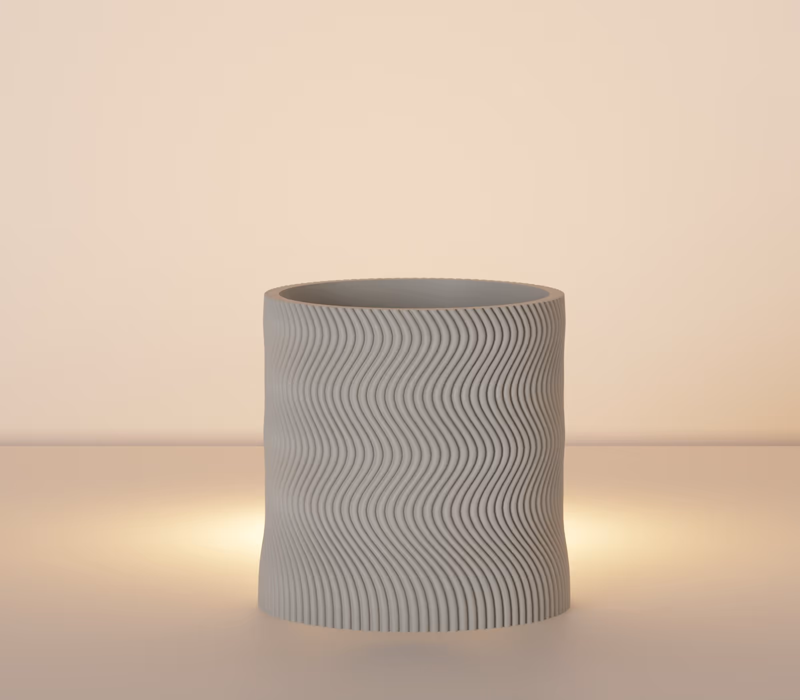 Gray cylindrical vase with wavy vertical ridges on a softly lit surface.