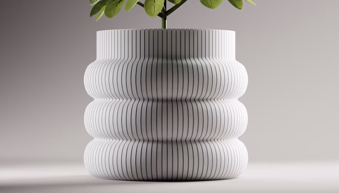 Modern white ceramic planter with vertical black stripes holding a green plant on a gray background.